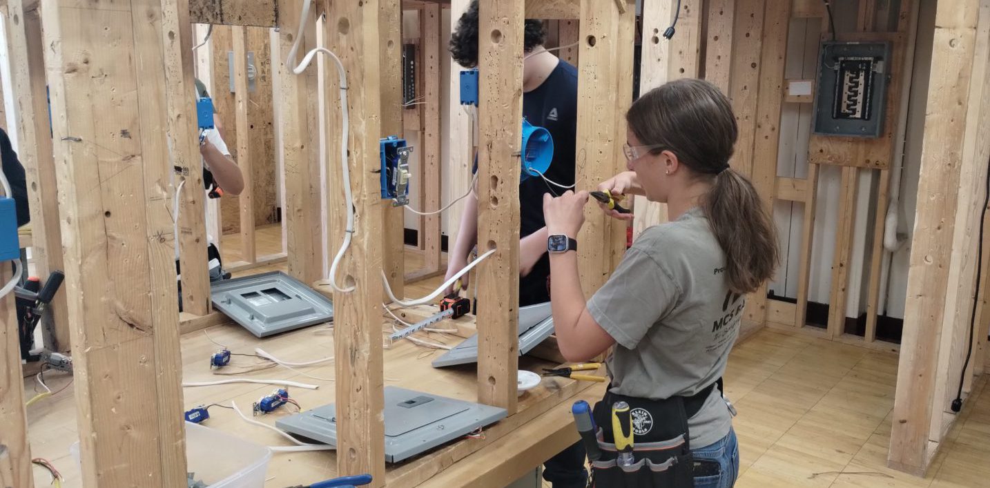 Woman and man working on electrical